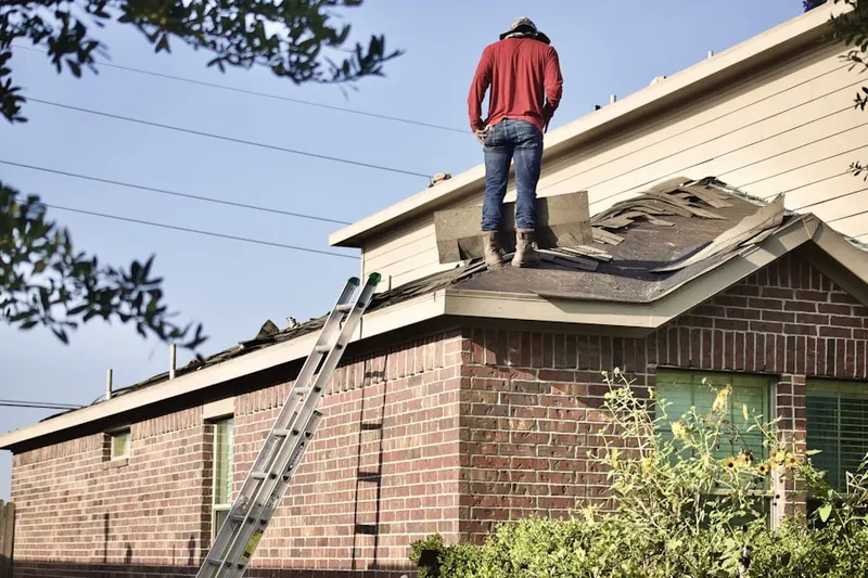 Professional roofer working on a residential roof in Biscayne Bay Village